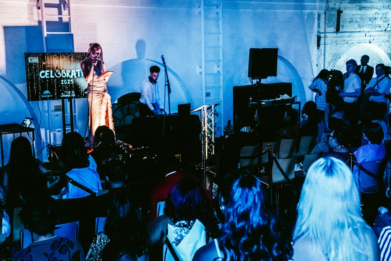 Stage and audience under blue lighting at CEL3BRATION 2025